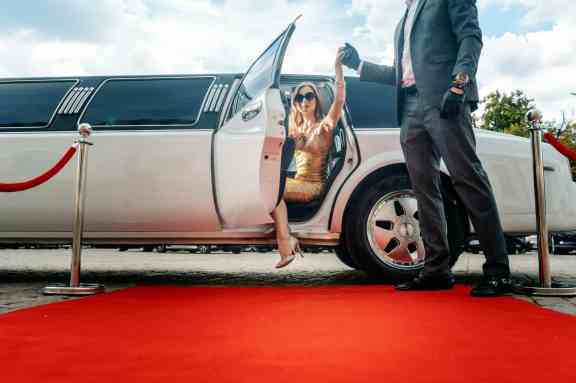 Woman coming out of limo for the red carpet